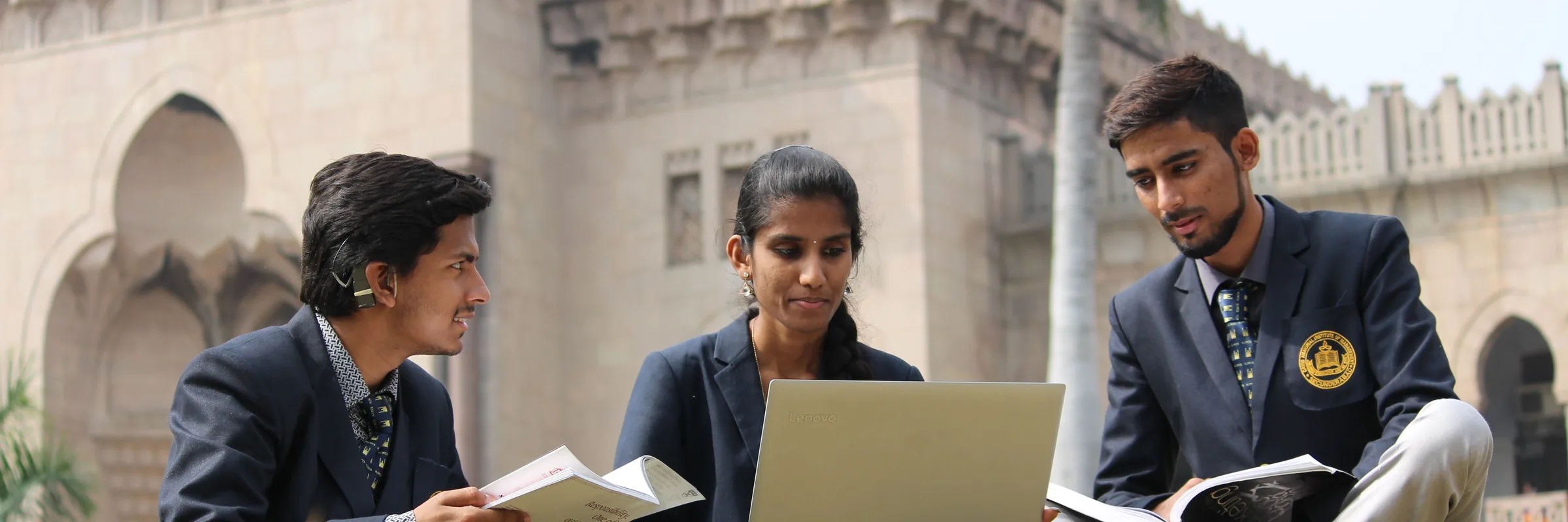 Indian university students studying together on a campus courtyard